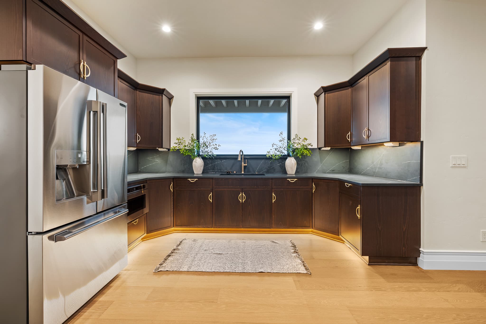 Warm wood kitchen island with marble countertop