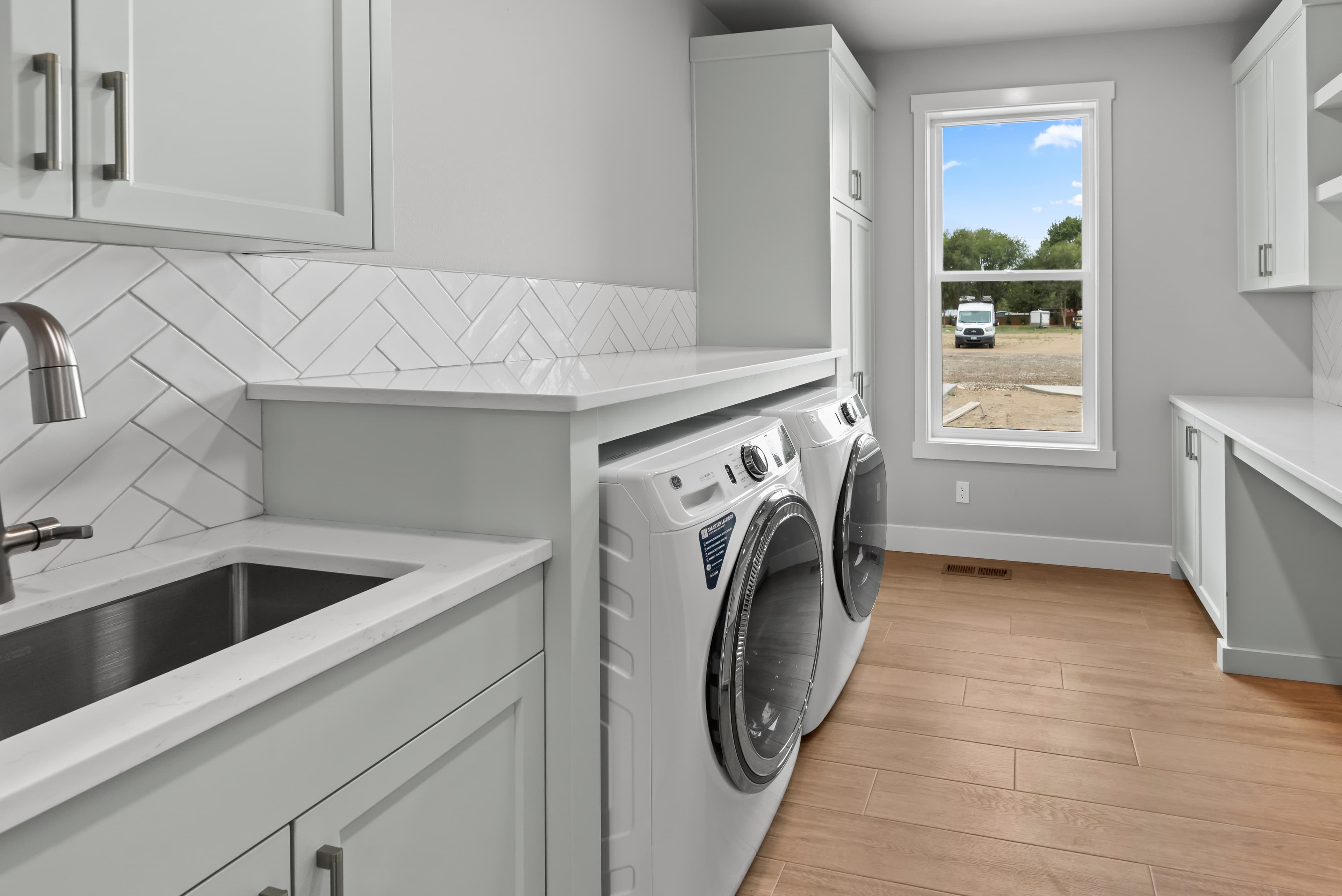 Laundry room with stacked washer and dryer