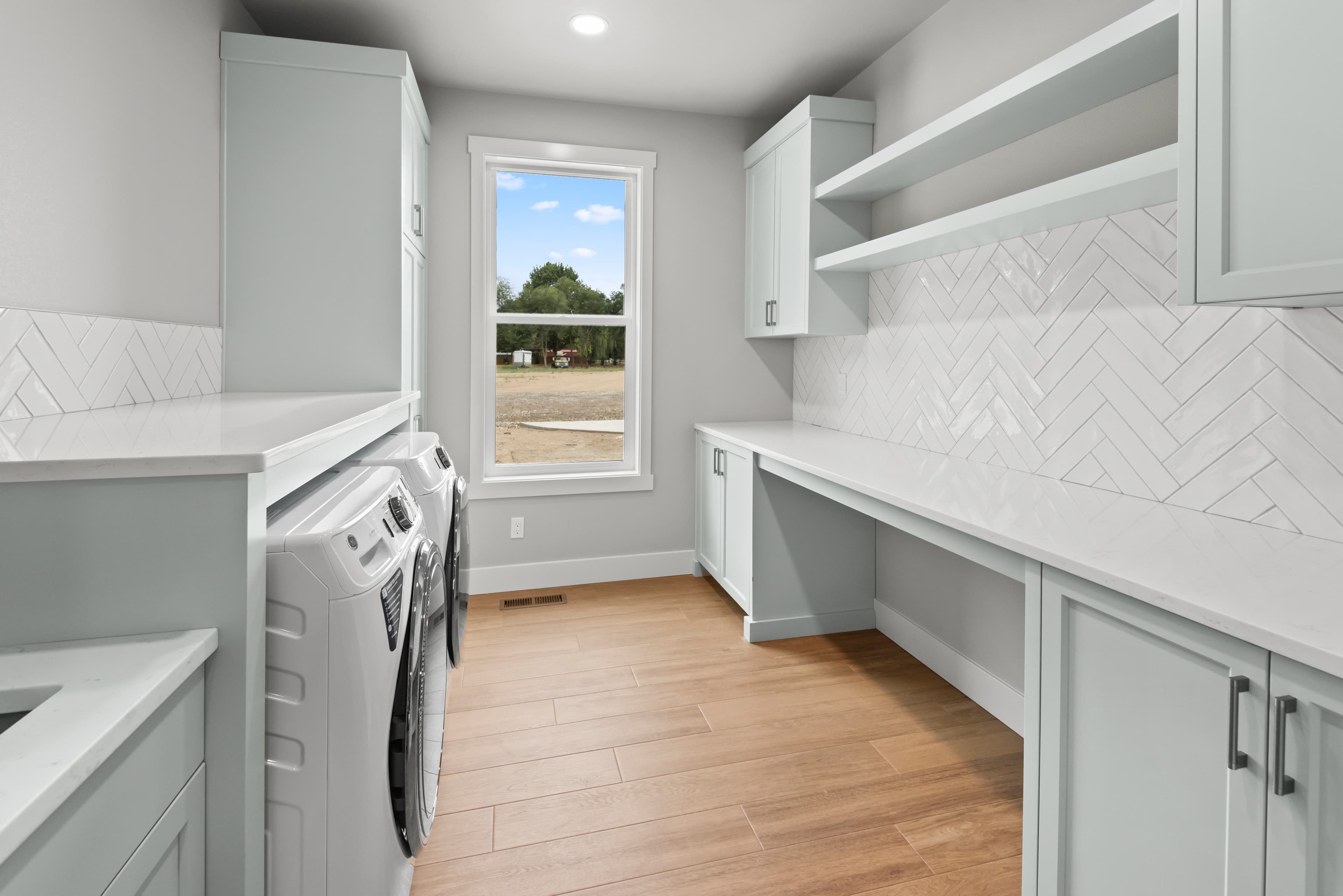 Laundry room with folding counter and herringbone tile