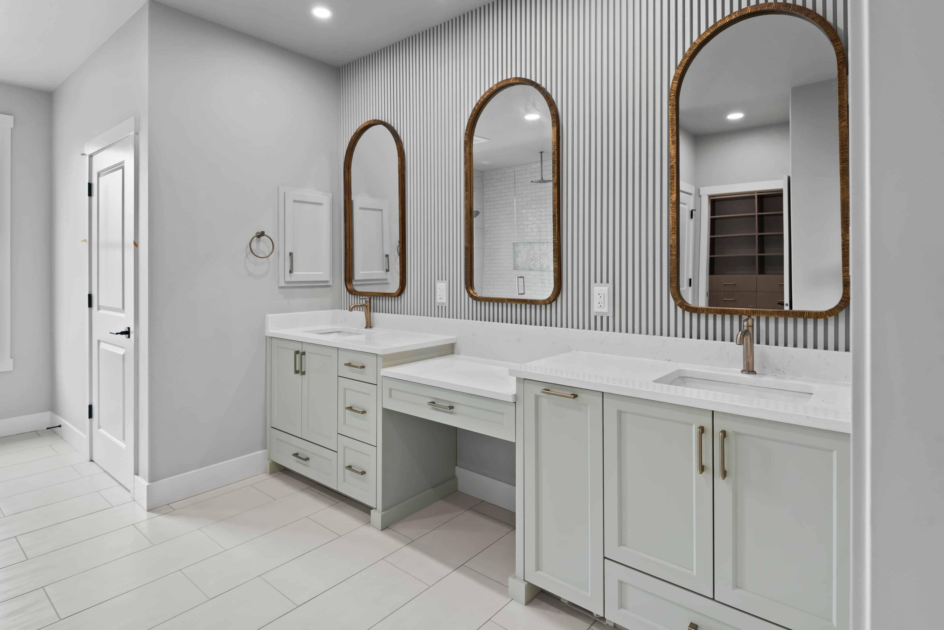 Sage green double vanity with arched mirrors